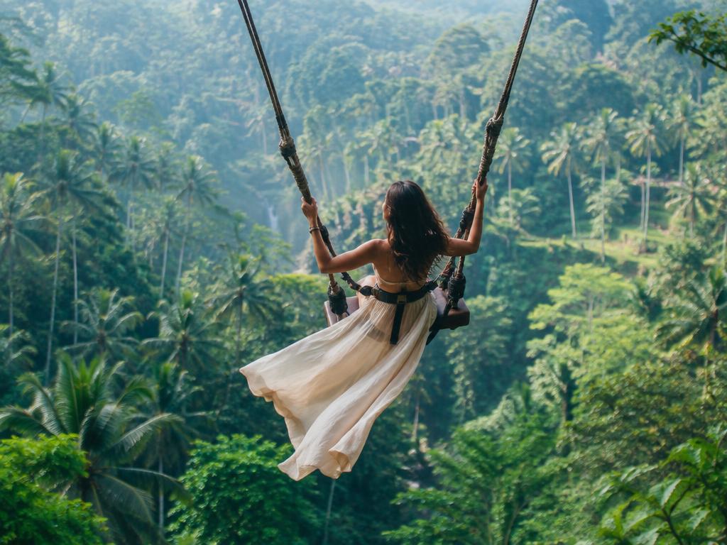 Jungle swing arcing over a lush Balinese valley